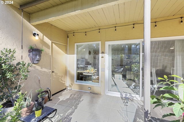 sunroom / solarium with beam ceiling and wood ceiling