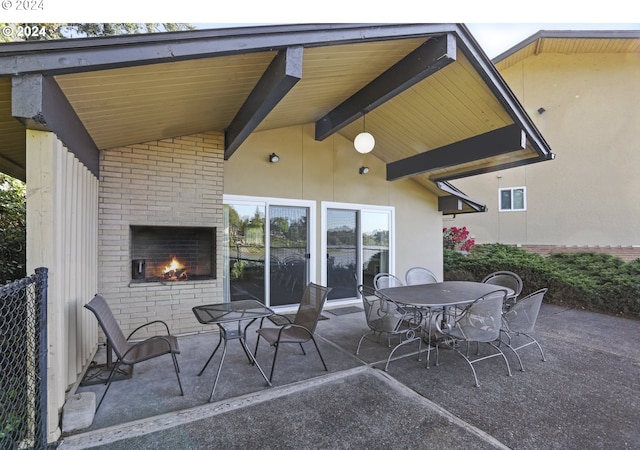 view of patio featuring an outdoor brick fireplace