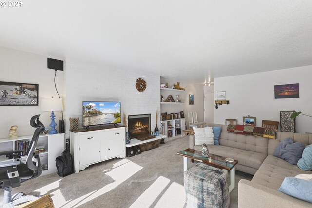 carpeted living room featuring a fireplace, a textured ceiling, and built in features