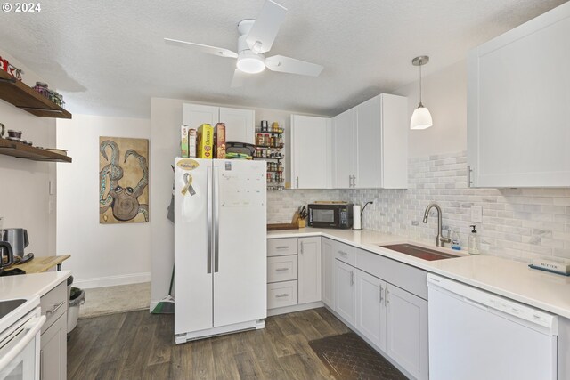 kitchen featuring pendant lighting, white appliances, and white cabinetry