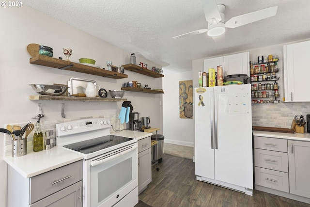 kitchen featuring white appliances, dark hardwood / wood-style floors, ceiling fan, decorative backsplash, and a textured ceiling