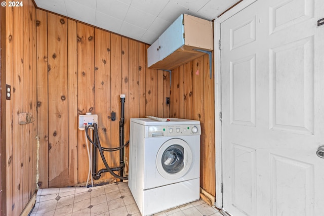 laundry area featuring washer / clothes dryer and wooden walls