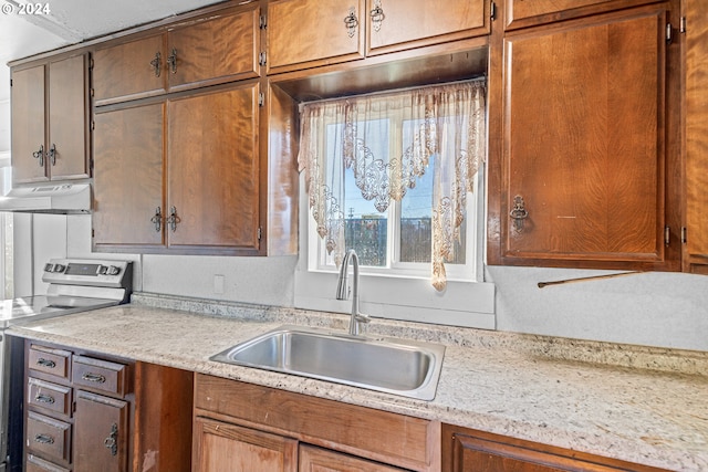 kitchen with electric range oven and sink