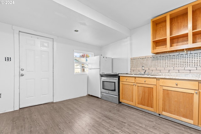 kitchen featuring tasteful backsplash, light hardwood / wood-style flooring, stainless steel range with electric cooktop, and white fridge