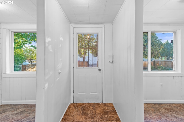 doorway featuring wooden walls