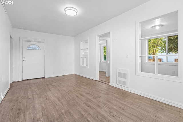 entrance foyer featuring hardwood / wood-style floors and heating unit