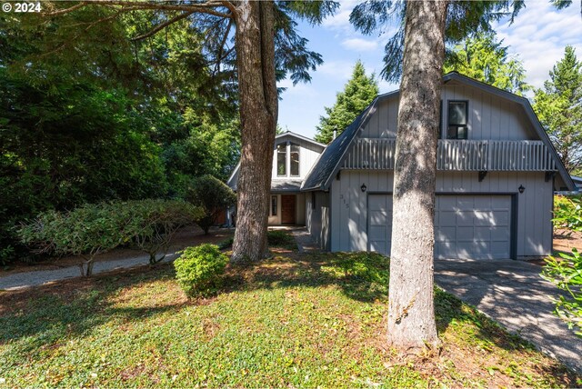 view of front of home with a garage and a front yard