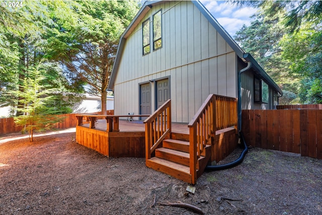back of property featuring fence and a deck