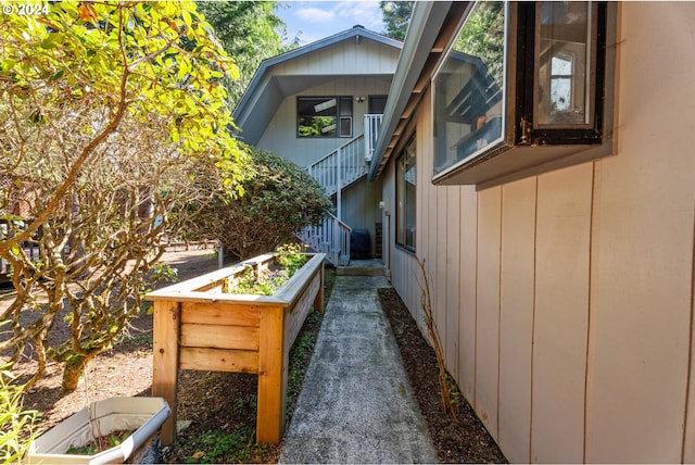 view of side of property featuring stairway