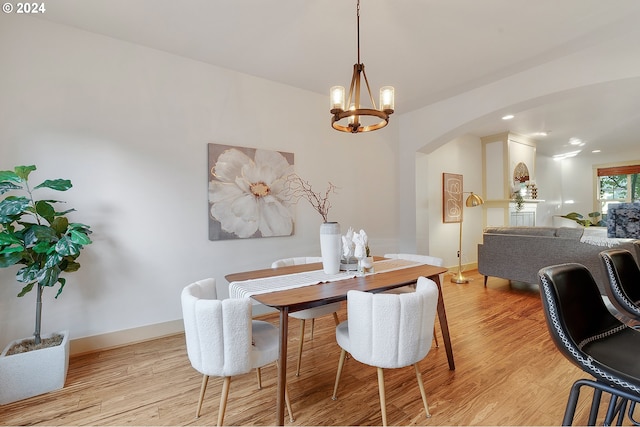 dining space with a chandelier and light wood-type flooring