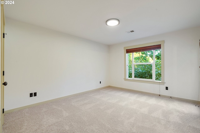 unfurnished room featuring light colored carpet