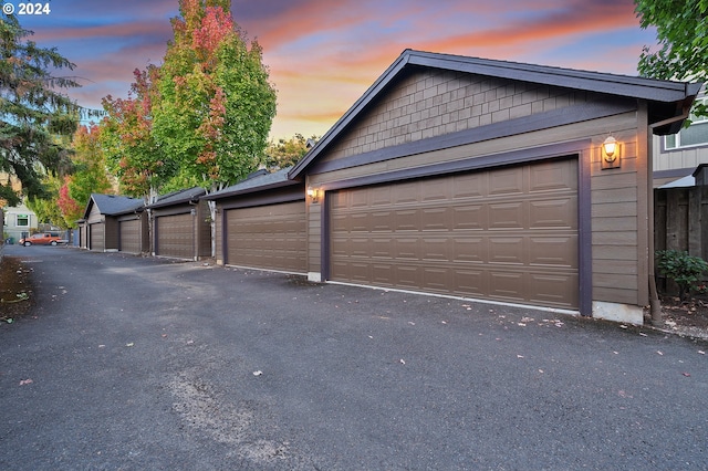 view of garage at dusk