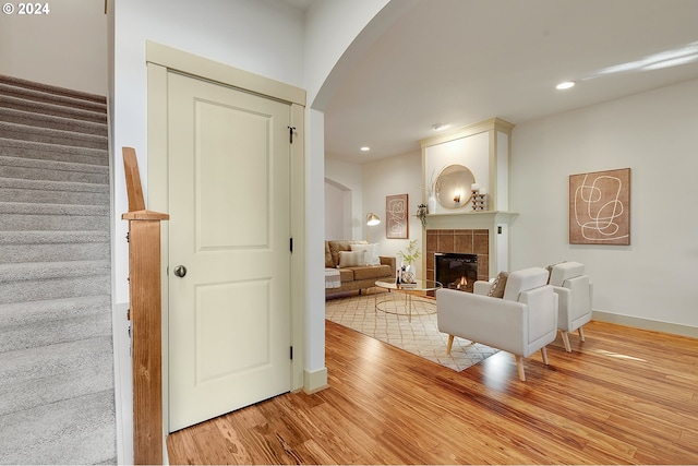 living room with a fireplace and light wood-type flooring