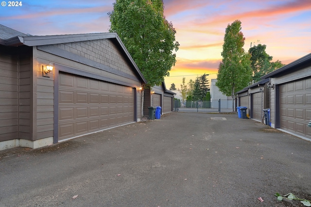 view of garage at dusk