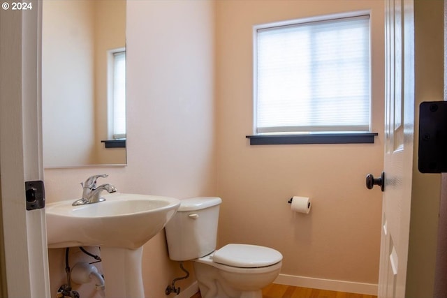 bathroom featuring wood-type flooring and toilet