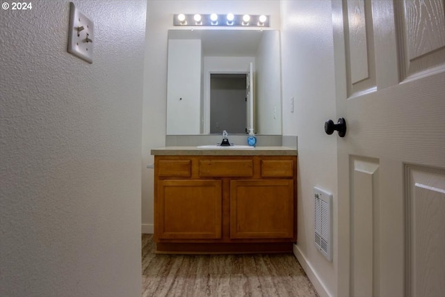 bathroom with vanity and wood-type flooring