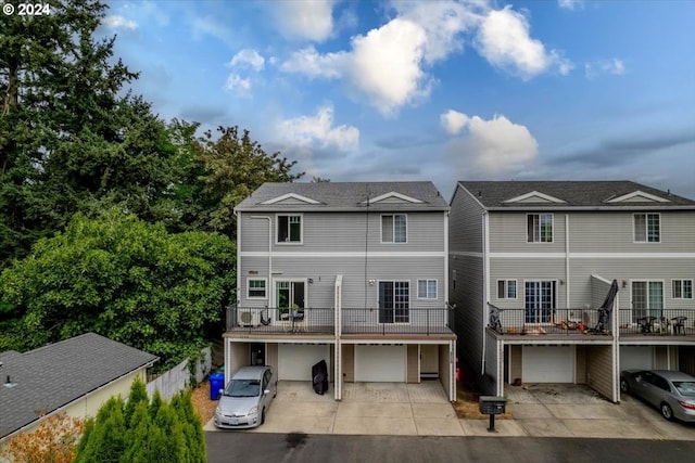 townhome / multi-family property with a garage and a balcony