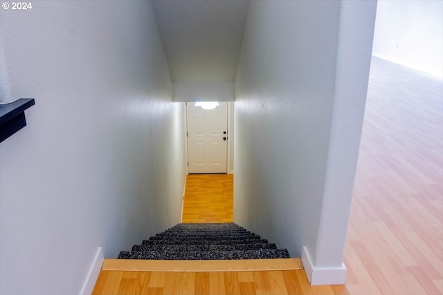 stairway with hardwood / wood-style floors