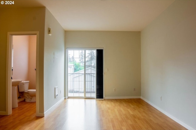 empty room with light hardwood / wood-style flooring