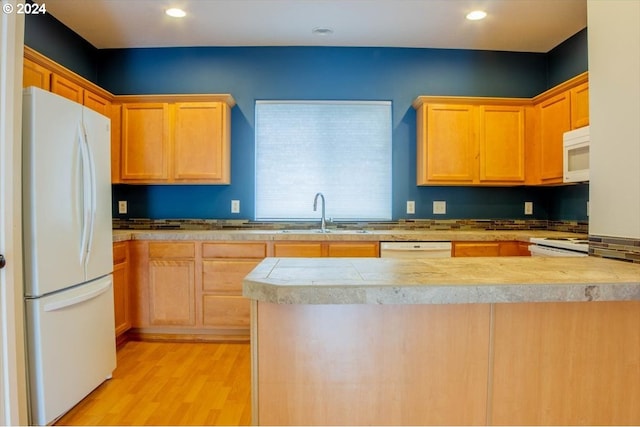 kitchen with white appliances, sink, and light wood-type flooring