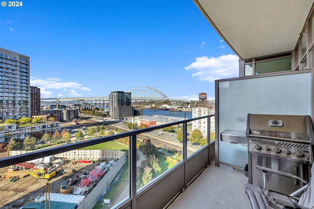 balcony with a water view and a grill