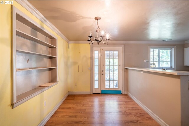 94213 Kerber Dr, Langlois, OR 97450 - doorway to outside with a chandelier, ornamental molding, wood finished floors, and baseboards