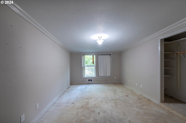 94213 Kerber Dr, Langlois, OR 97450 - spare room featuring ornamental molding, baseboards, a textured ceiling, and unfinished concrete flooring