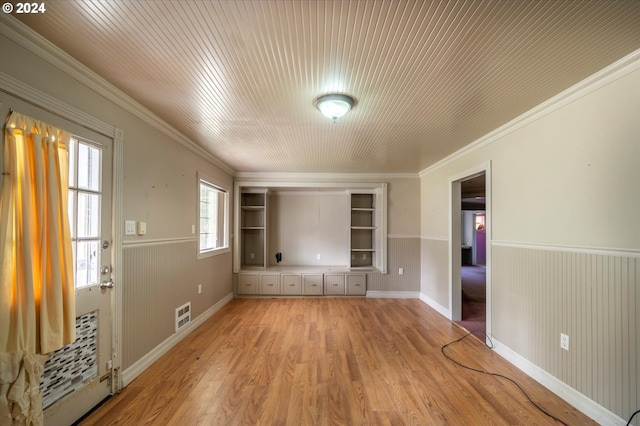 94213 Kerber Dr, Langlois, OR 97450 - unfurnished room with light wood-style flooring, crown molding, built in features, wainscoting, and baseboards