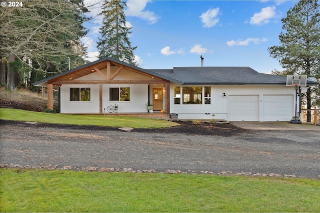 ranch-style home with a front yard and a garage