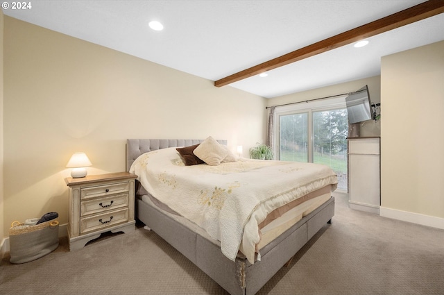 carpeted bedroom featuring beamed ceiling