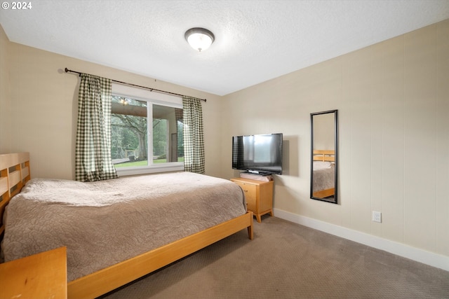 carpeted bedroom featuring a textured ceiling