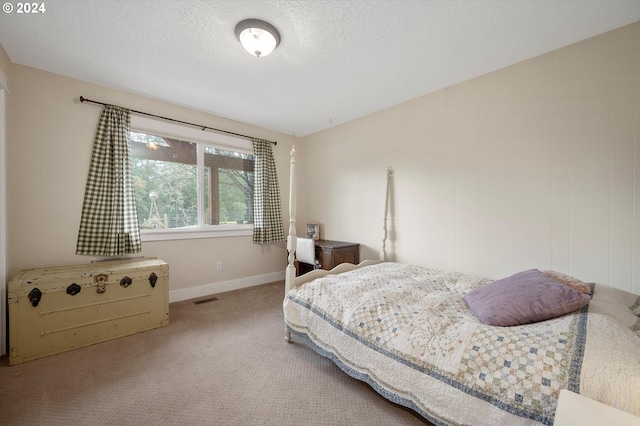 bedroom featuring carpet and a textured ceiling