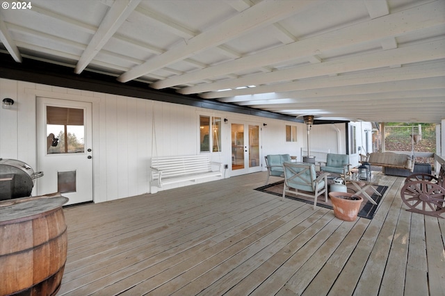 wooden deck featuring an outdoor living space and french doors