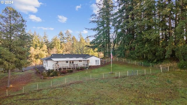 exterior space with a lawn, a rural view, and a deck