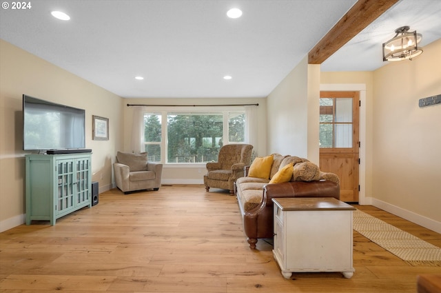 living room featuring beam ceiling and light wood-type flooring