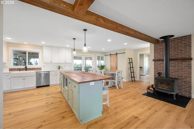 kitchen featuring a center island, light hardwood / wood-style flooring, hanging light fixtures, and appliances with stainless steel finishes