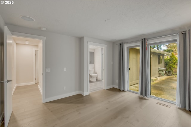 interior space with light hardwood / wood-style floors and a textured ceiling