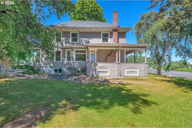 rear view of property with a lawn