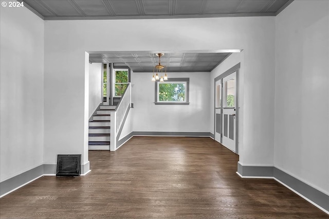 interior space featuring dark wood-type flooring and a chandelier