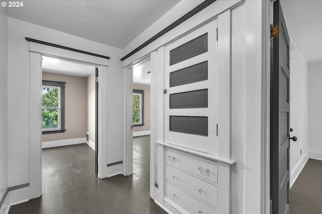 hallway featuring dark hardwood / wood-style flooring