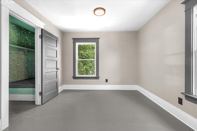 unfurnished bedroom featuring concrete flooring