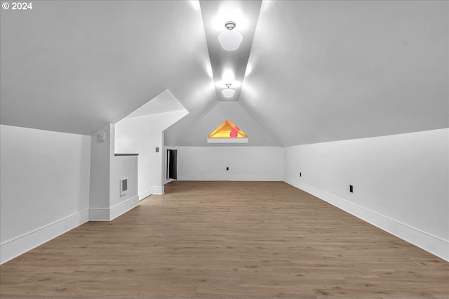 bonus room featuring hardwood / wood-style floors and vaulted ceiling