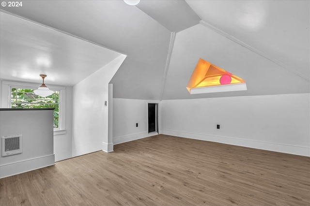 bonus room with hardwood / wood-style floors and vaulted ceiling