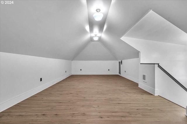 bonus room featuring light hardwood / wood-style flooring and vaulted ceiling