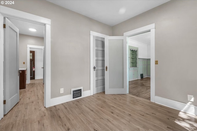 unfurnished bedroom featuring a closet and light hardwood / wood-style flooring