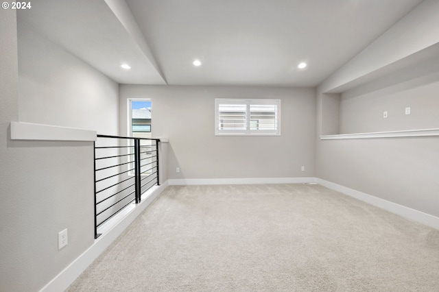 basement featuring light carpet