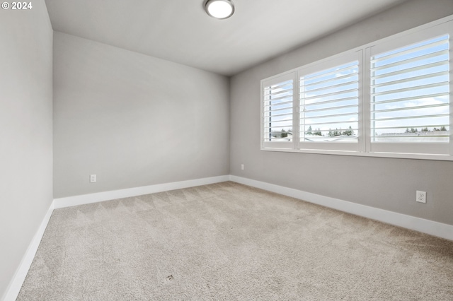 unfurnished room with light colored carpet