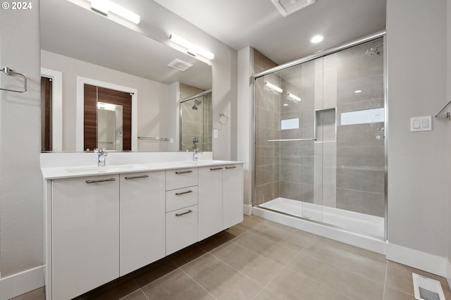 bathroom featuring a shower with door, tile patterned floors, and vanity