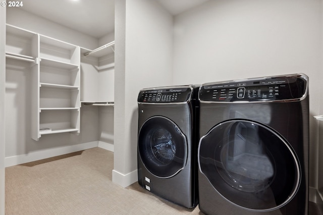 laundry room with light carpet and separate washer and dryer