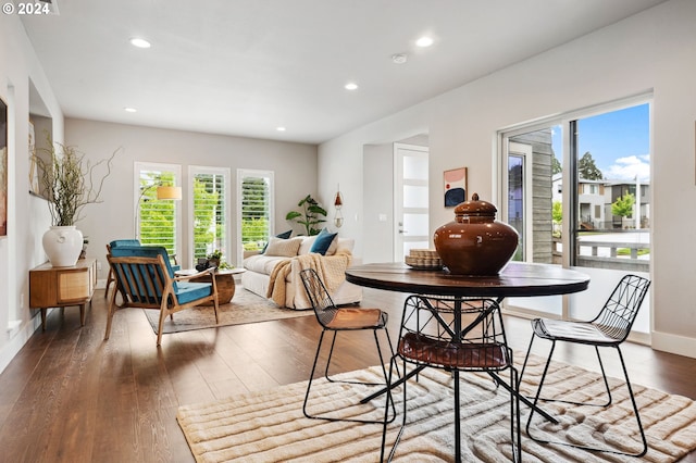 dining space with wood-type flooring